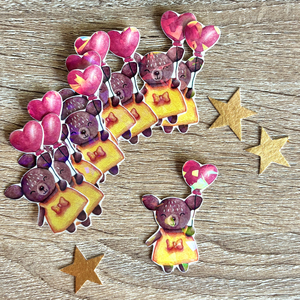 sticker représentant une biche avec un ballon en forme de cœur holographique