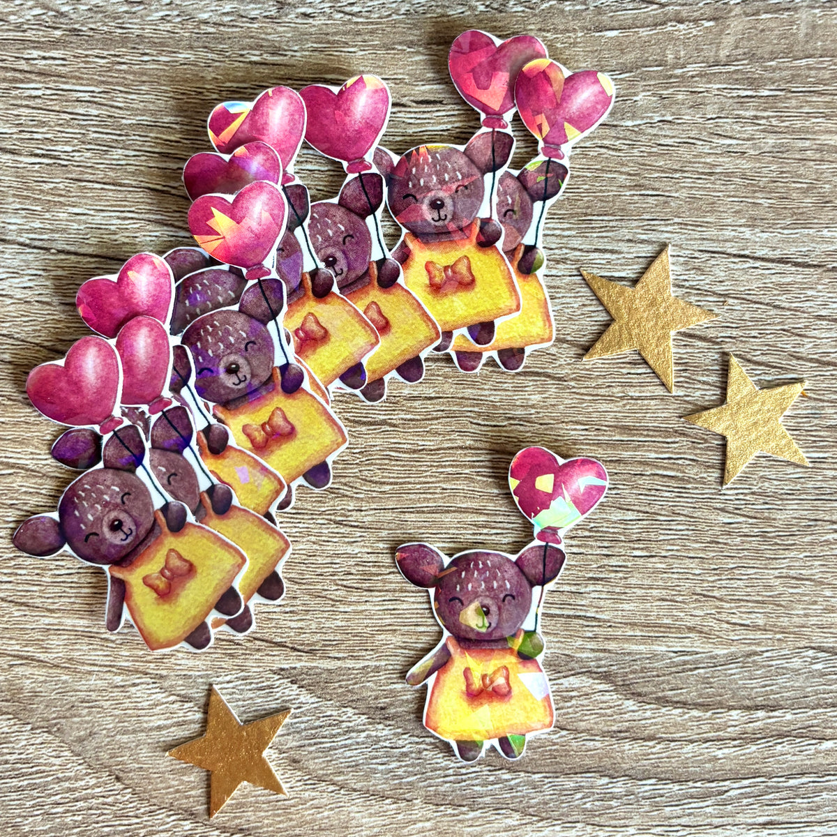 sticker représentant une biche avec un ballon en forme de cœur holographique